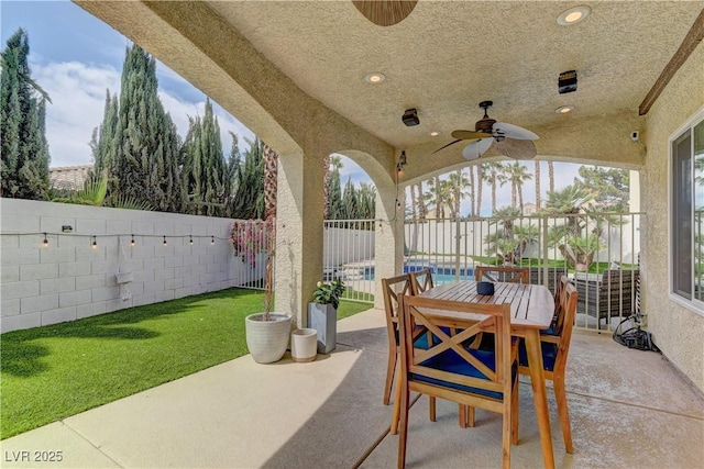 view of patio / terrace with ceiling fan, outdoor dining area, and a fenced backyard