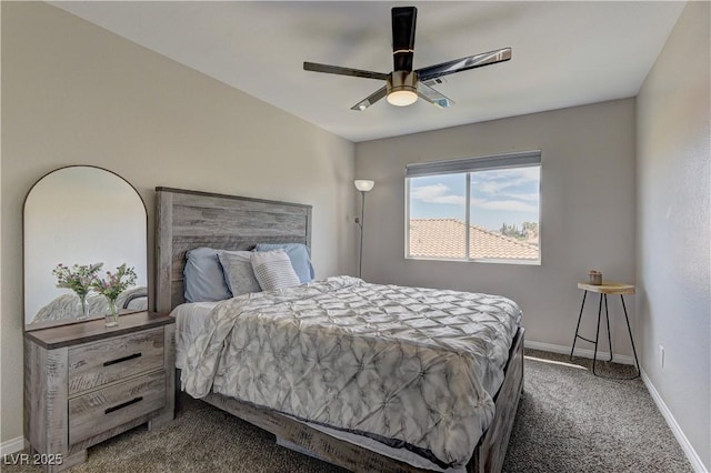 bedroom with ceiling fan, dark carpet, and baseboards