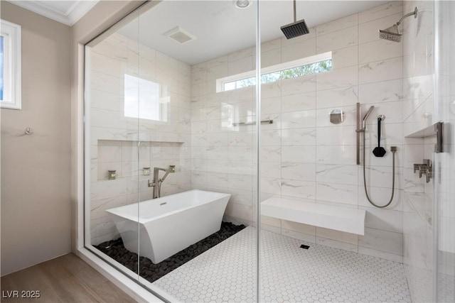 full bathroom with a soaking tub, wood finished floors, a shower stall, and crown molding
