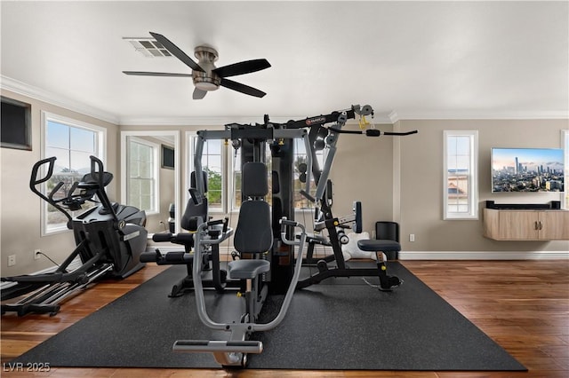 workout room featuring baseboards, ornamental molding, a ceiling fan, and wood finished floors