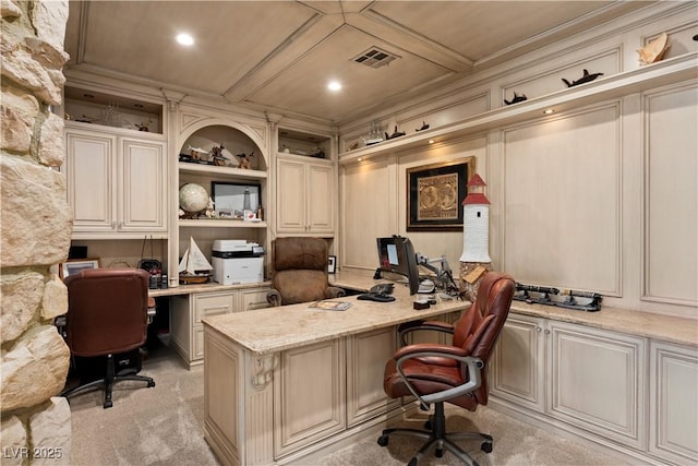 home office with visible vents, light carpet, ornamental molding, and built in study area