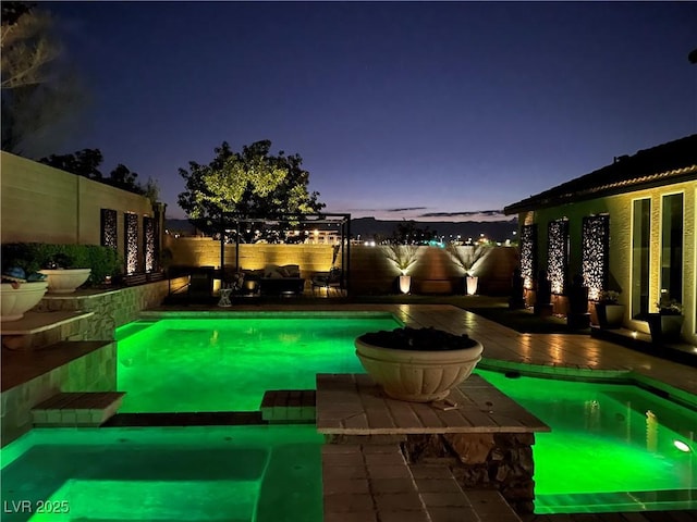 view of swimming pool featuring a fenced backyard, a wooden deck, and a pool with connected hot tub