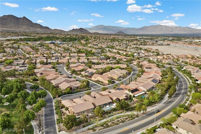 drone / aerial view featuring a residential view and a mountain view