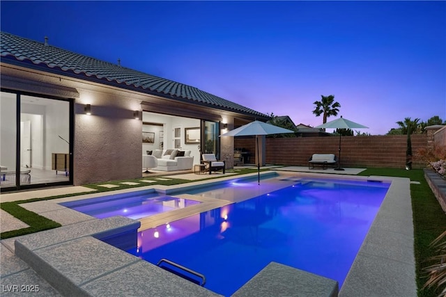 pool at dusk featuring a fenced in pool, a patio, an in ground hot tub, and a fenced backyard