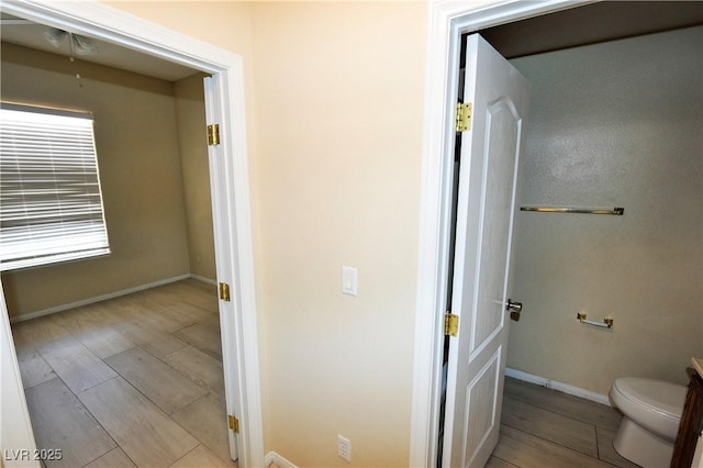 bathroom featuring wood finished floors and toilet
