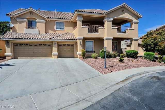 mediterranean / spanish home with stucco siding, a tiled roof, a balcony, and concrete driveway
