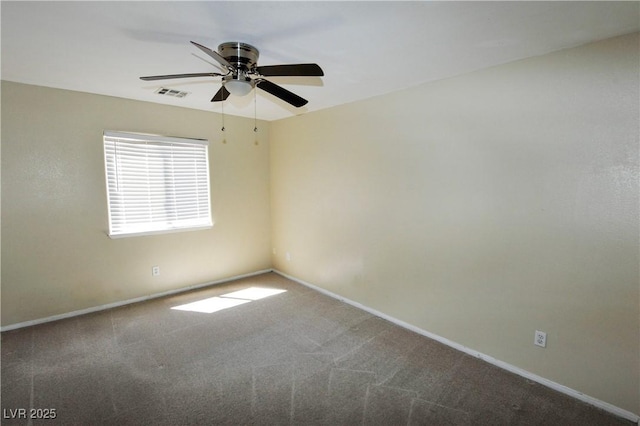 spare room featuring baseboards, visible vents, ceiling fan, and carpet