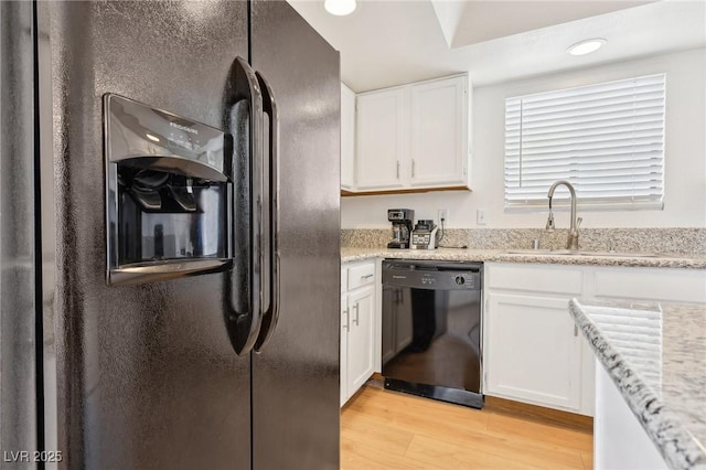 kitchen with light wood-style floors, black dishwasher, white cabinets, a sink, and refrigerator with ice dispenser