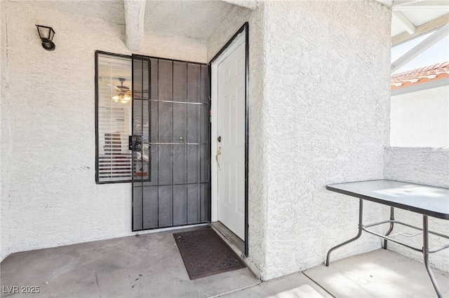 entrance to property with stucco siding