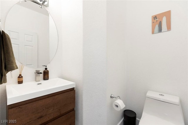 bathroom with toilet and vanity