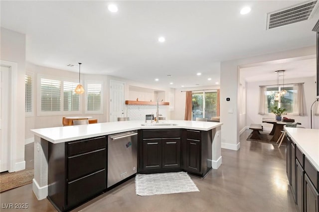 kitchen with dishwasher, a sink, baseboards, light countertops, and recessed lighting