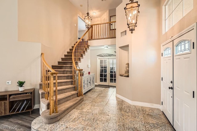 13 Cozy Glen Cir, Henderson, NV 89074 - foyer entrance with visible vents, an inviting chandelier, baseboards, a high ceiling, and stairway