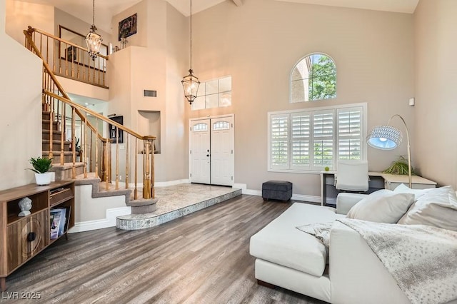 13 Cozy Glen Cir, Henderson, NV 89074 - living room with a towering ceiling, visible vents, wood finished floors, a chandelier, and stairs
