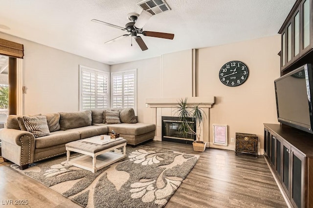 13 Cozy Glen Cir, Henderson, NV 89074 - living room with ceiling fan, visible vents, a wealth of natural light, and wood finished floors