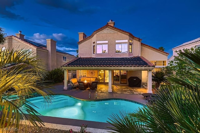 13 Cozy Glen Cir, Henderson, NV 89074 - back of house featuring a patio area, stucco siding, and an outdoor pool