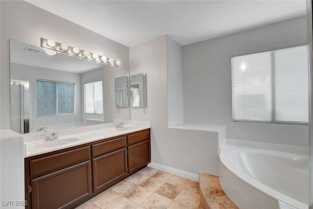 8236 Bermuda Beach Dr, Las Vegas, NV 89128 - bathroom with a sink, baseboards, a garden tub, and double vanity