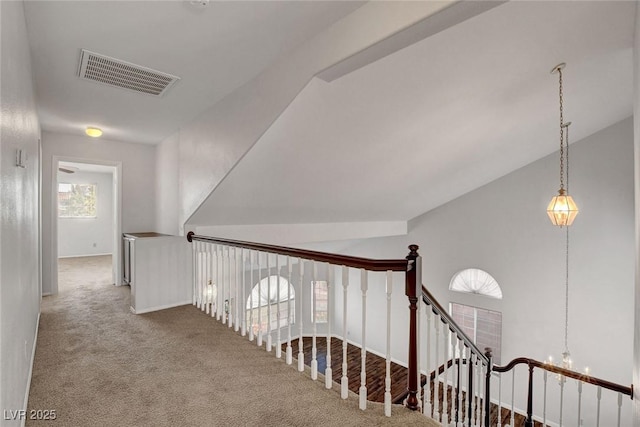 8236 Bermuda Beach Dr, Las Vegas, NV 89128 - hall featuring carpet floors, an upstairs landing, vaulted ceiling, and a chandelier