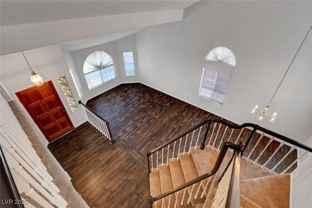 8236 Bermuda Beach Dr, Las Vegas, NV 89128 - entryway with a notable chandelier, stairs, baseboards, wood finished floors, and a towering ceiling