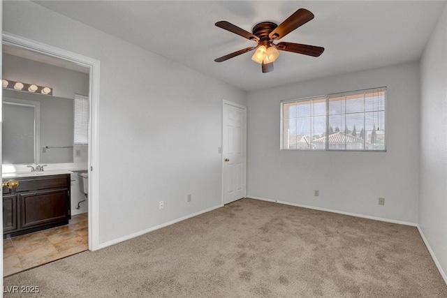 8236 Bermuda Beach Dr, Las Vegas, NV 89128 - unfurnished bedroom featuring ceiling fan, light colored carpet, a sink, baseboards, and connected bathroom