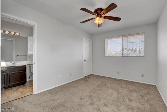 8236 Bermuda Beach Dr, Las Vegas, NV 89128 - unfurnished bedroom featuring light carpet, ensuite bathroom, and a ceiling fan