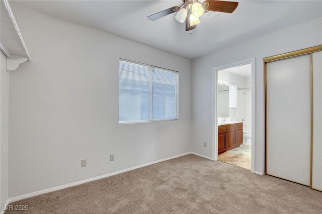8236 Bermuda Beach Dr, Las Vegas, NV 89128 - unfurnished bedroom featuring light carpet, ensuite bathroom, a closet, and a ceiling fan