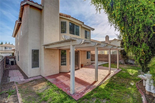 8236 Bermuda Beach Dr, Las Vegas, NV 89128 - rear view of property featuring a lawn, a patio area, a fenced backyard, a pergola, and stucco siding