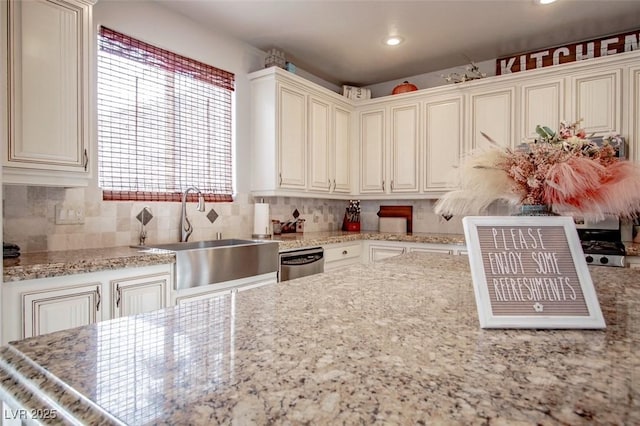 1125 Via Canale Dr, Henderson, NV 89011 - kitchen with recessed lighting, a sink, decorative backsplash, light stone counters, and stainless steel dishwasher