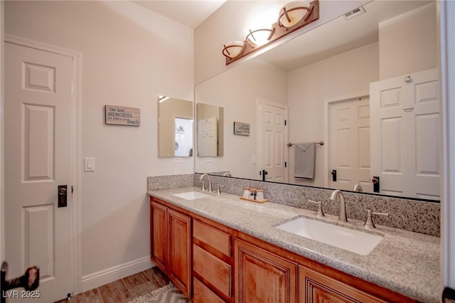 1125 Via Canale Dr, Henderson, NV 89011 - full bath featuring double vanity, wood finished floors, visible vents, and a sink