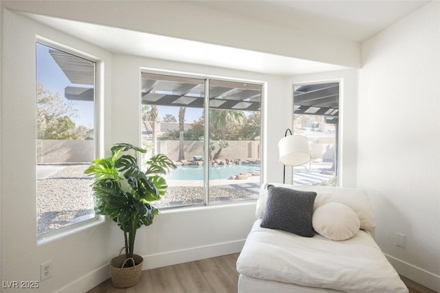 living area with wood finished floors and baseboards