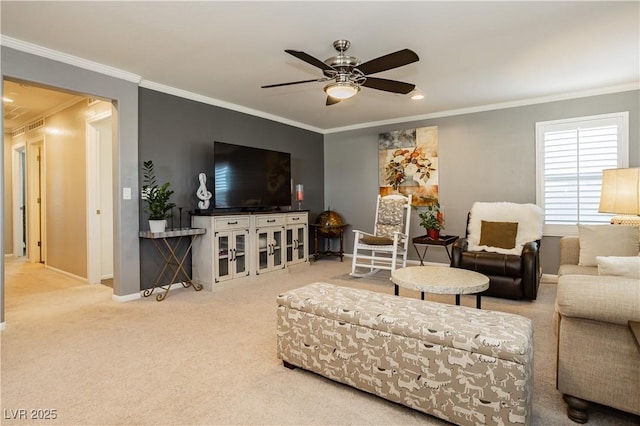 living area featuring ornamental molding, ceiling fan, carpet flooring, and baseboards