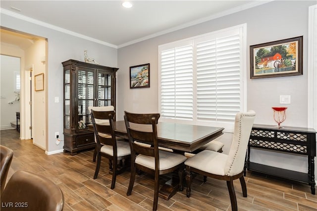 dining room with ornamental molding, a wealth of natural light, and wood finished floors
