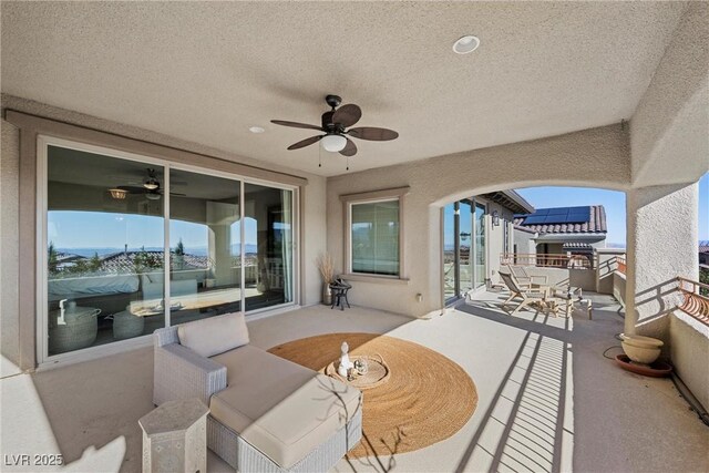 view of patio / terrace featuring a ceiling fan and a balcony