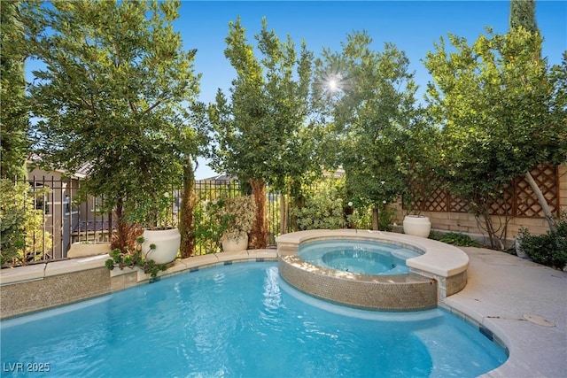 view of swimming pool with a fenced in pool, a fenced backyard, and an in ground hot tub