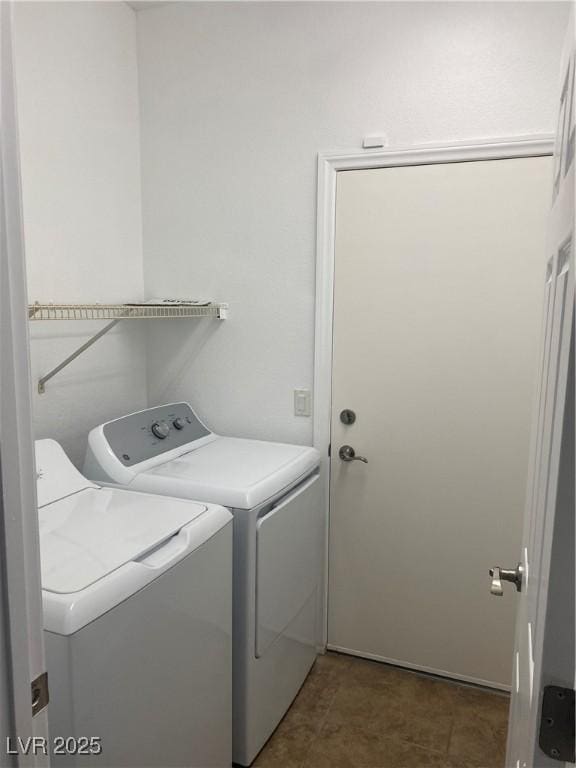 washroom with independent washer and dryer and laundry area