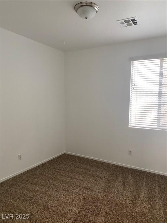 empty room with visible vents, baseboards, and carpet floors