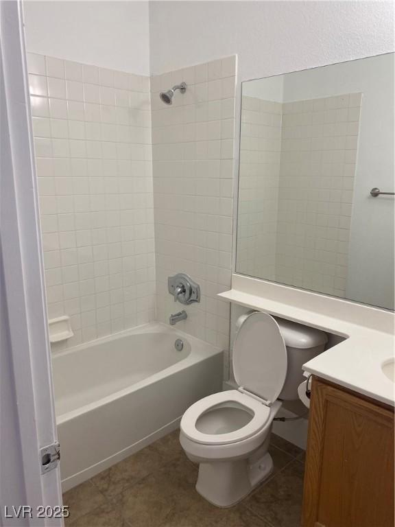 full bathroom featuring toilet, tile patterned flooring, bathing tub / shower combination, and vanity