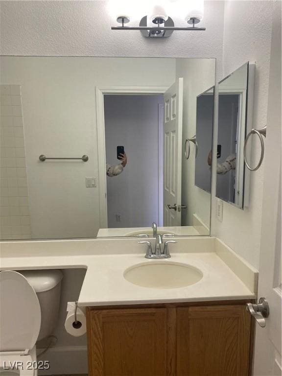 bathroom featuring toilet and vanity