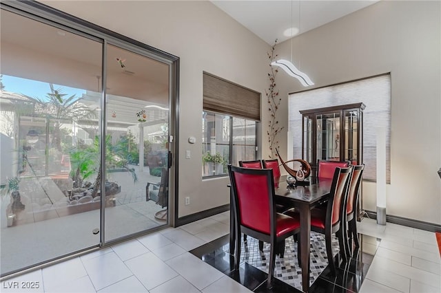 tiled dining room with baseboards