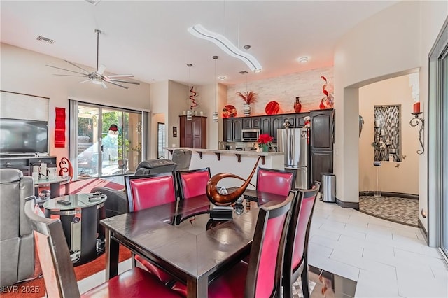 dining space featuring ceiling fan and visible vents