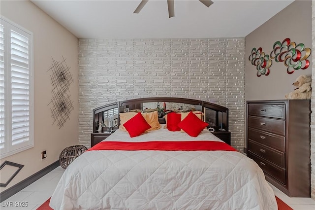 bedroom featuring an accent wall, ceiling fan, and baseboards