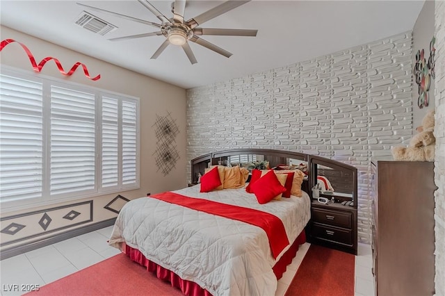 bedroom featuring tile patterned flooring, visible vents, and ceiling fan