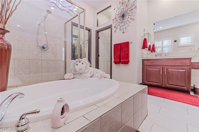 full bath with tile patterned floors, vanity, a bath, and tiled shower