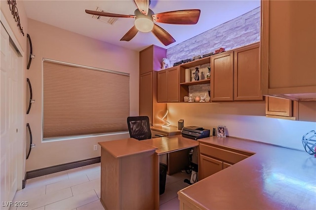 home office with built in desk, a ceiling fan, and visible vents