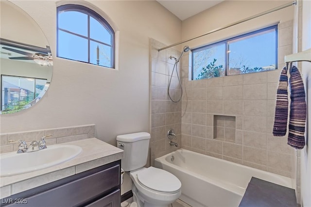 full bathroom with toilet, ceiling fan, vanity, and  shower combination