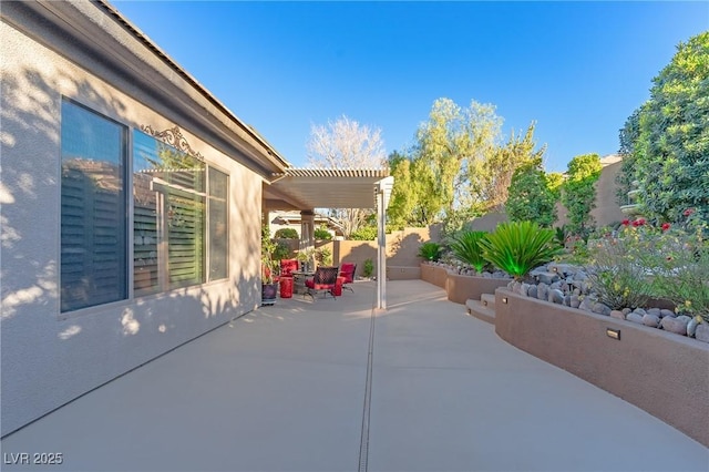 view of patio / terrace with a pergola and a fenced backyard