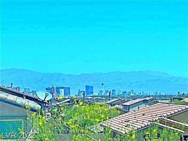 exterior space featuring a city view and a mountain view