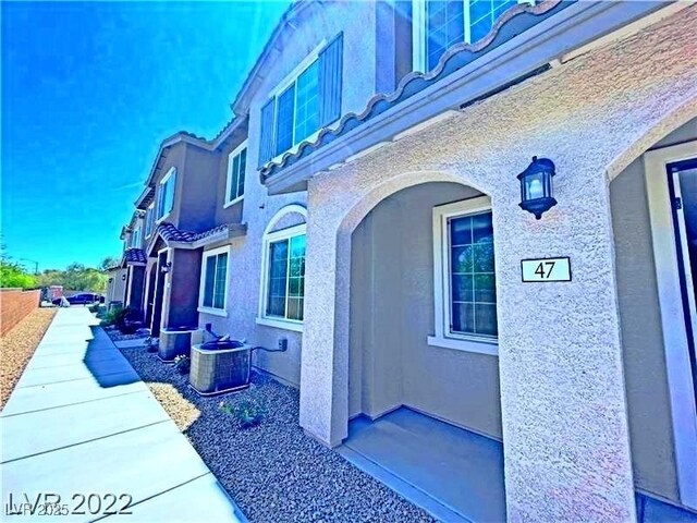 view of property exterior featuring stucco siding and central AC