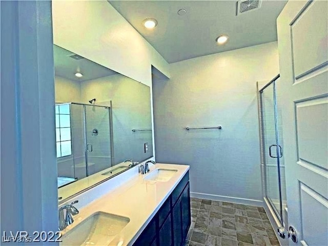 full bath featuring visible vents, a stall shower, and a sink