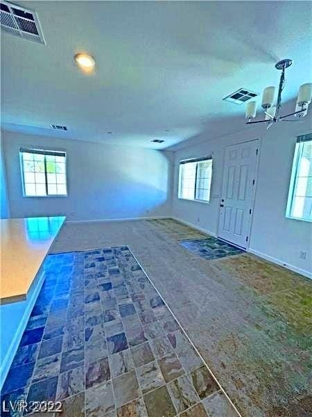 entrance foyer featuring visible vents, recessed lighting, a notable chandelier, and baseboards