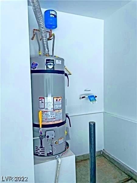 utility room featuring strapped water heater